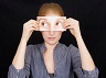 woman-holding-print-out-of-eyes-over-face